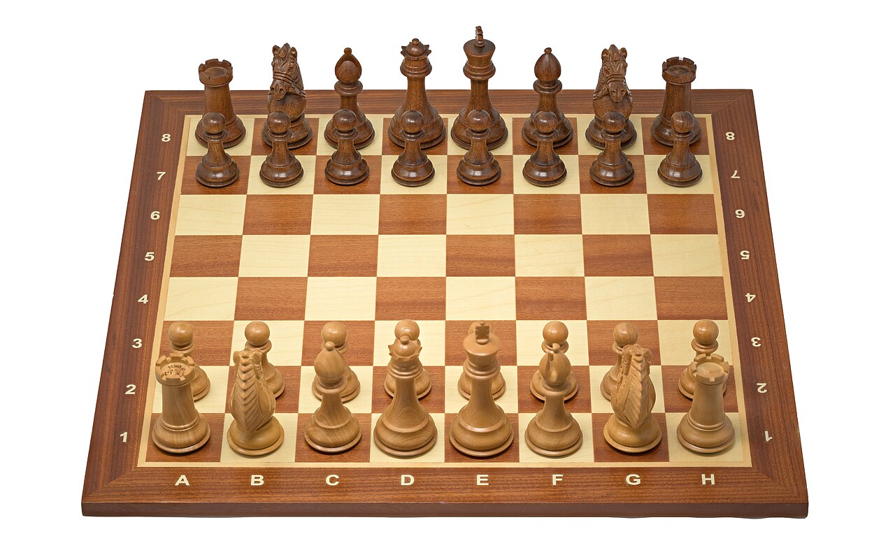 The Rio Staunton Chess Set by House of Chess is renowned for its distinctive craftsmanship and functional design, featuring chess pieces made from Ringy Rosewood and Boxwood. Each piece is triple weighted to enhance stability during gameplay, with beveled bases and billiard cloth green pads to minimize surface abrasion. A standout piece is the Biggie Knight, which is hand-carved with detailed features such as pronounced eyes and a braided mane, offering a robust and striking appearance. The pieces are individually hand-polished, resulting in a semi-gloss finish that accentuates the wood's natural color and grain. The set includes additional queens for pawn promotion and each piece fits securely into individual foam inserts within the board, ensuring they remain stationary and protected. The total weight of the chess pieces is approximately 3.5 pounds, with the board weighing about 6.5 pounds, bringing the complete set to around 10 pounds. Additionally, the Wegiel Handmade Wooden Chess Board is an 18.9-inch square tournament-sized board, ideal for both professional play and hobbyists seeking a high-quality gaming surface. Crafted from mahogany and sycamore woods, these materials are chosen for their durability and the rich, contrasting colors they provide, enhancing the visual appeal of the board. The board measures 18.9 inches in length and width, with a height of 0.6 inches. Each square on the board is 2 inches, a standard size for tournament play, which facilitates better visibility and movement of pieces during games. An important feature of this chessboard is its craftsmanship, evident in the precision of its inlays and the smooth finish of each square. The design includes numbered and lettered algebraic coordinates along the borders, aiding in game analysis and learning.