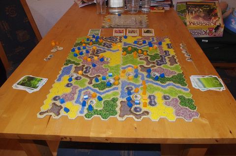 a completed game of Kingdom Builder on a wooden table