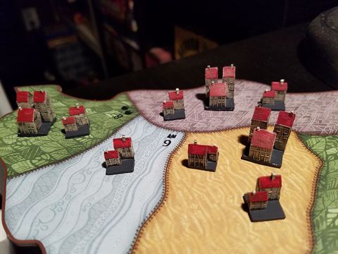 Painted buildings in Spirit Island board game.