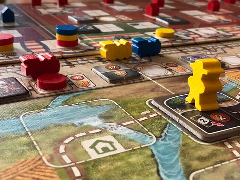 Closeup of the game board of Great Western Trail.
