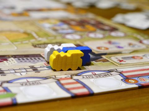 Delivery track with three trains in the board game Great Western Trail.