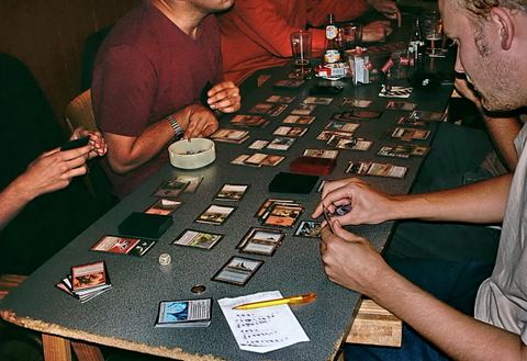 People playing the collectible card game Magic: The gathering.