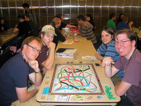 PAX 2008 attendees playing the board game Ticket to Ride
